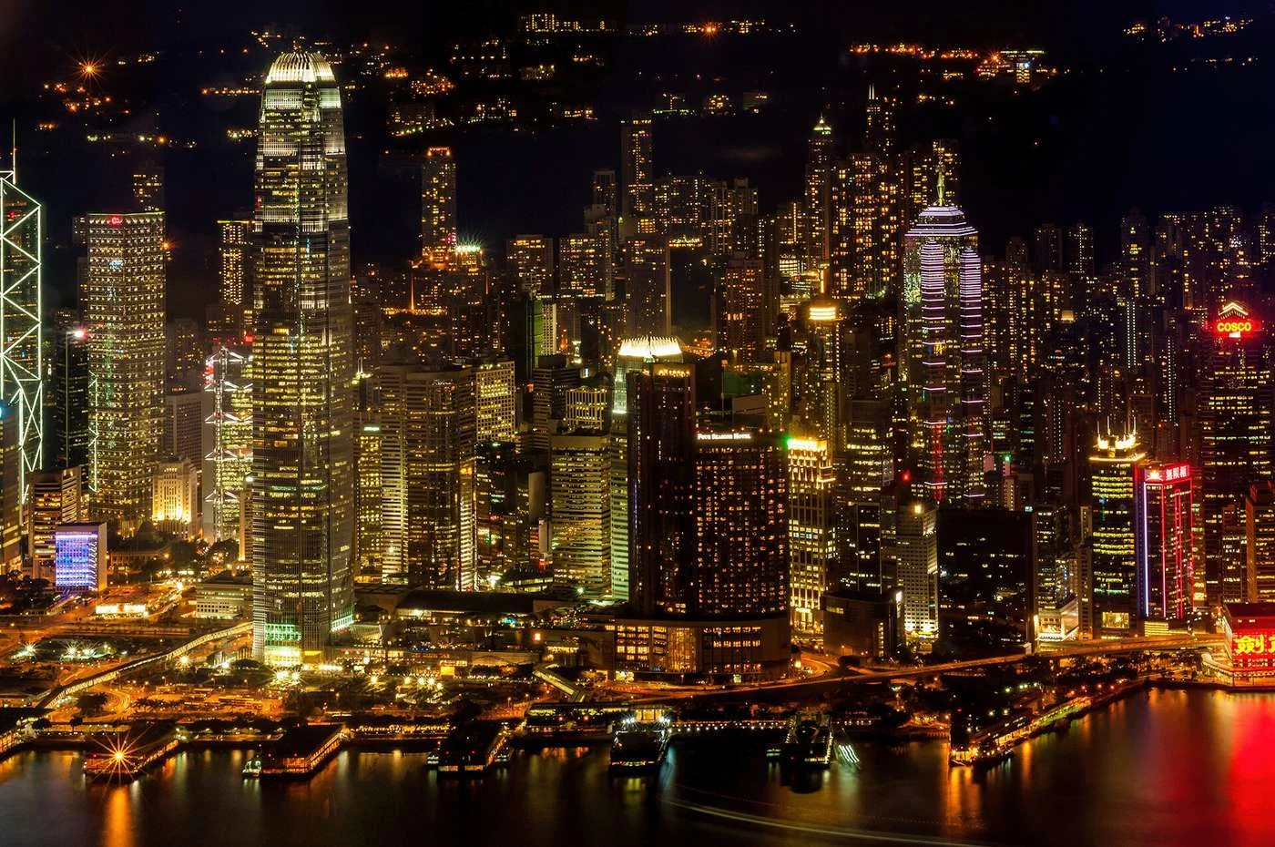 Hong Kong skyscrapers lit up along Victoria Harbour at night