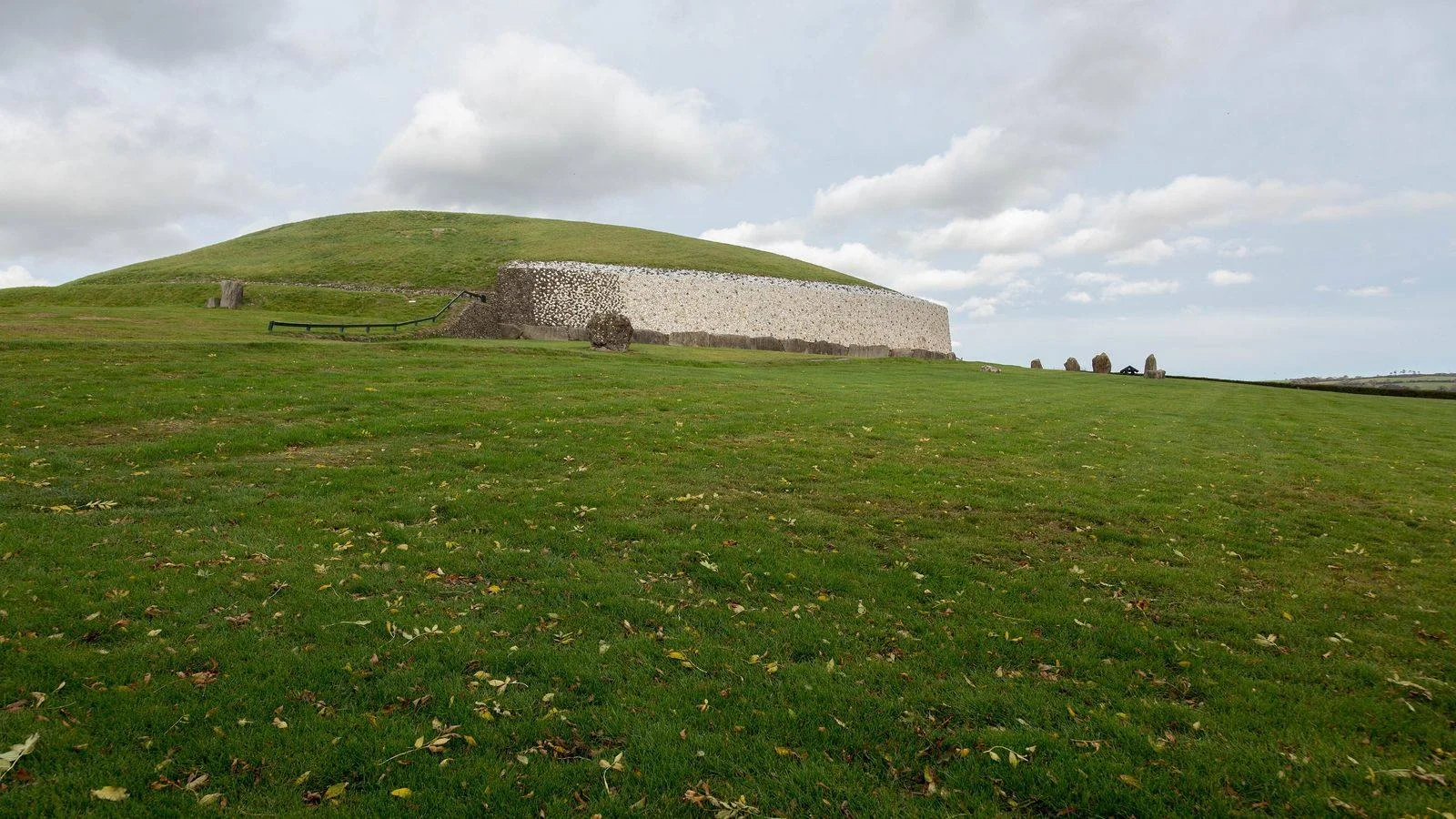 The grass-covered mound and white quartz facade of Newgrange passage tomb in the Boyne Valley, Ireland